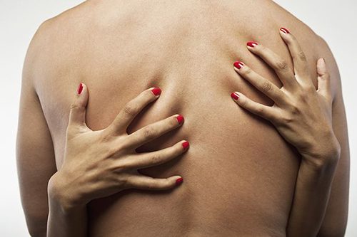 womans hands embracing mans torso